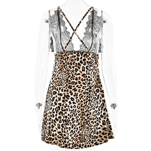 Detail of cross back straps and black lace patchwork on leopard print satin dress