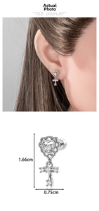 Detail view of silver heart and cross stud earring with dimensions 1.66cm by 0.75cm