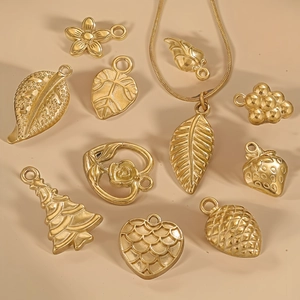 Collection of gold stainless steel pendants featuring floral, leaf, and heart DIY shapes