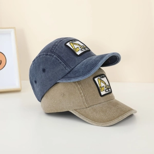 Detail of vintage washed baseball caps with excavator embroidery in navy and khaki