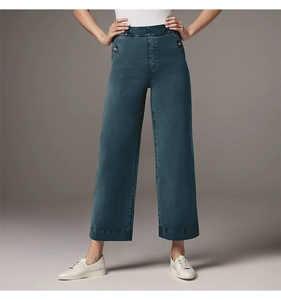 Detail of high-waisted wide-leg straight denim trousers in dark teal with white sneakers