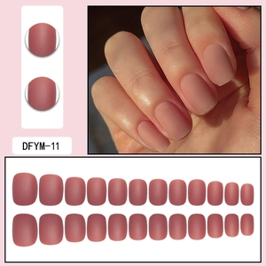 Detail of matte short square-round press-on nails in elegant mauve pink finish