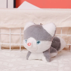 Detailed macro shot of grey husky plush keychain with blue eyes and metal chain
