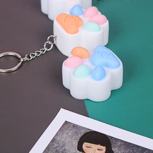 Macro detail of cat paw keychain silicone molds in macaron colors with metal chain link