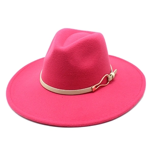 Detailed macro of rose pink wool fedora featuring narrow beige leather band and gold buckle