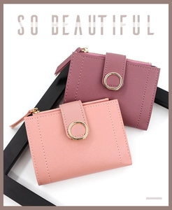 Detail view of pink and mauve PU leather wallets with gold ring buckle and side zipper pocket