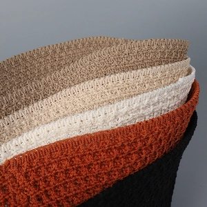 Macro view of multi-color hollow knit bucket hats showing texture and weave detail