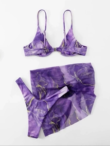 Flat lay of purple marble bikini with gold accents and matching sheer beach sarong