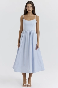 Close-up of light blue midi dress showing thin straps and waist detail on studio model