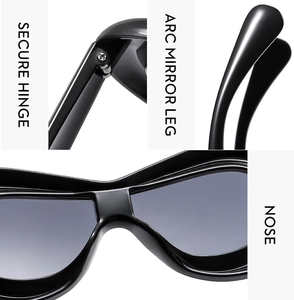 Detail view of secure hinge, arc mirror leg and nose pads on black Y2K sunglasses