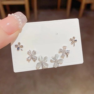 Three pairs of elegant clover stud earrings with opal and cubic zirconia stones