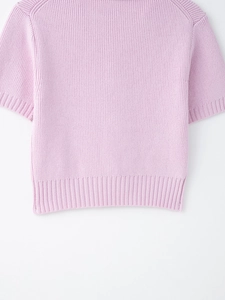 Detail of lavender knit top featuring ribbed hem and fine texture for women