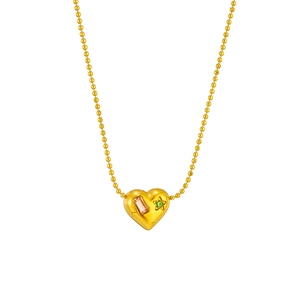 Gold heart pendant necklace with pink and green gems on a delicate bead chain
