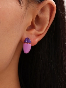 Detailed view of bicolor enamel oval earring in purple with artistic dotted pattern decoration