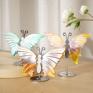 Detailed view of colorful translucent butterfly resin crafts on silver metal stands