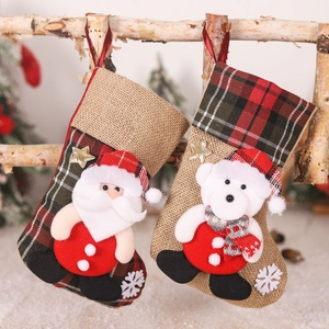 Christmas stockings set with Santa and Polar Bear figures hanging on wooden branch