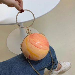 Pink and yellow sphere acrylic handbag with sparkling rhinestone handle and gold chain strap