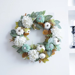 Autumn wreath with white pumpkins, hydrangeas, and maple leaves for Thanksgiving wall decor