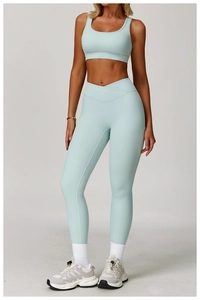 Detail view of high-waist yoga pants featuring a unique V-shaped crossover waist design