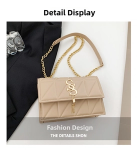 Detail view of beige quilted shoulder bag with gold S-logo and metal tassel charms