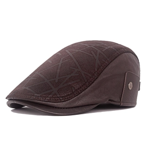 Detail view of brown leather duckbill cap with cross patterns and side metal button