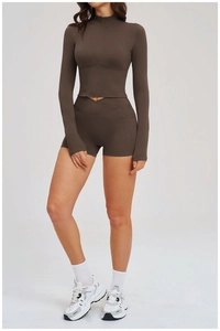 Detail of high-waist fitness shorts with V-waistband and zipper sports jacket
