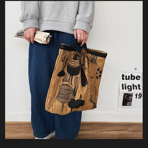 Detail of canvas tote bag with vegetable illustrations and large capacity design