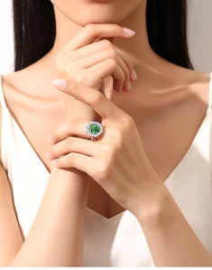 Detailed view of luxury S925 sterling silver ring with halo emerald green gemstone