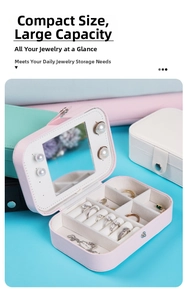 Pink PU leather jewelry box detail with inner mirror, ring slots, and storage compartments