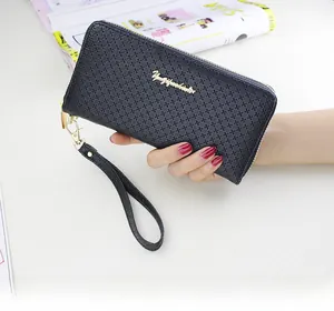 Detail of black cross-pattern leather long wallet with golden logo and wristlet strap