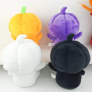 Rear view of four plush Halloween pumpkins in orange purple white and black with CE tags