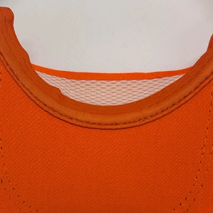 Detail of orange visor cap showing double stitching and white breathable mesh lining