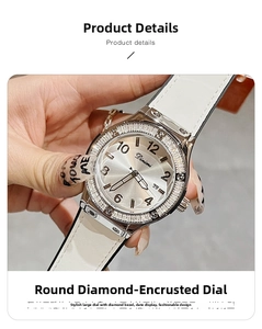 Detail of silver watch dial with rhinestone bezel, calendar window and white leather strap