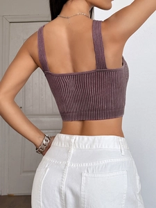 Back view of a Fuchsia ribbed knit cropped tank top with wide straps and elastic fabric