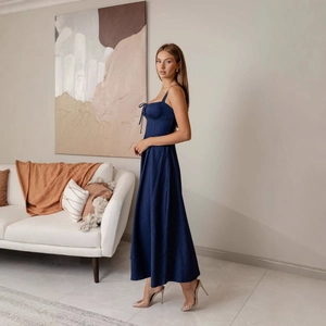 Fashionable dark blue backless denim sundress with waist cinching and long flowy hemline