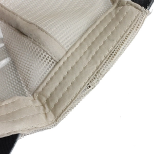 Detailed macro view of beige mesh trucker hat inner seams and sweatband stitching
