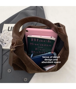 Top view of spacious interior of brown tote bag with tablet and books storage