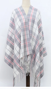 Detail of pink and grey plaid scarf with decorative tassels on a mannequin