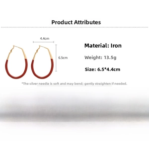 Detail view of retro red drop earrings showing 6.5cm by 4.4cm dimensions and iron material