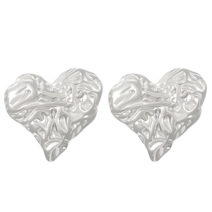 Close-up of silver heart earrings with vintage crumpled foil texture in stainless steel
