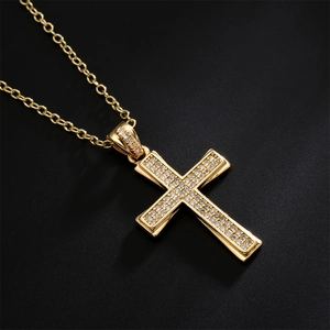 Golden 18K gold plated cross necklace with sparkling clear zircons on black background