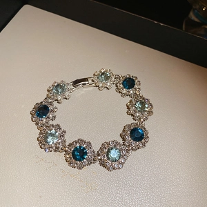 Macro detail of vintage floral bracelet with blue gemstones and silver settings