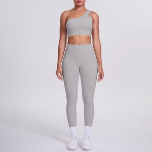 Front view of light grey one-shoulder sports bra and high-waisted yoga leggings set