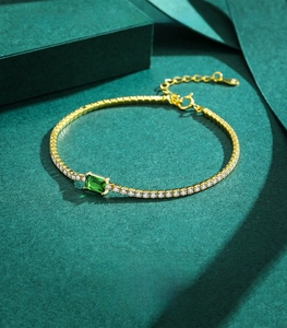 Detailed macro view of 925 sterling silver tennis bracelet with green emerald zircon