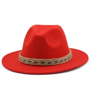 Detail of red wool felt fedora hat featuring a woven ethnic style decorative band