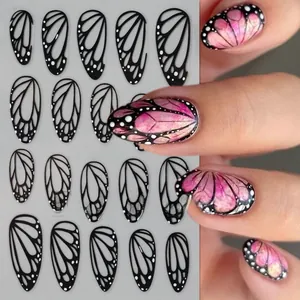 Detail of black butterfly wing nail stickers with white dots and realistic application