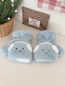 Detail of light blue plush mittens with cute headphones decor and thick thermal fleece lining