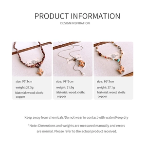 Detailed view of handmade fabric rocking horse necklaces with wood and copper accents