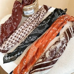 Detail showing five assorted vintage patterns of lightweight silk scarves for women