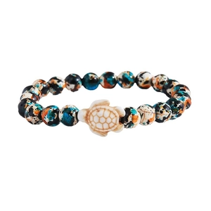 Unisex colorful turquoise and wood bead bracelet with a white turtle charm on white background